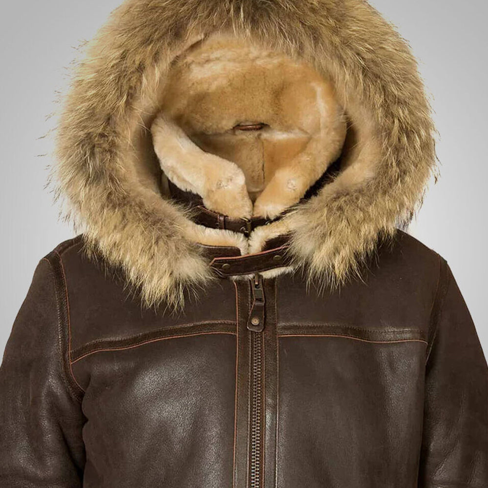 Close up view of fur trimmed hood and double buckle leather throat latch straps on aviator jacket