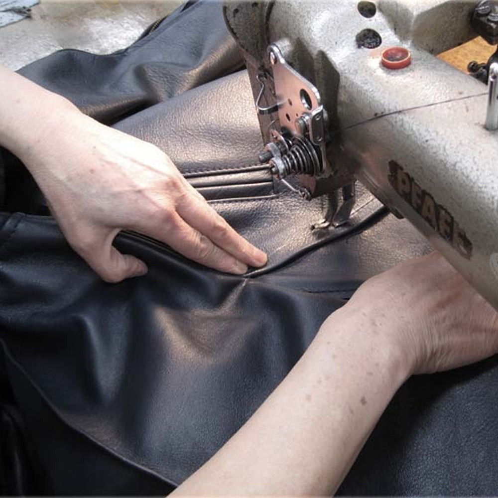 Stitching process of the men's brown suede lambskin leather jacket, showcasing expert craftsmanship and attention to detail.