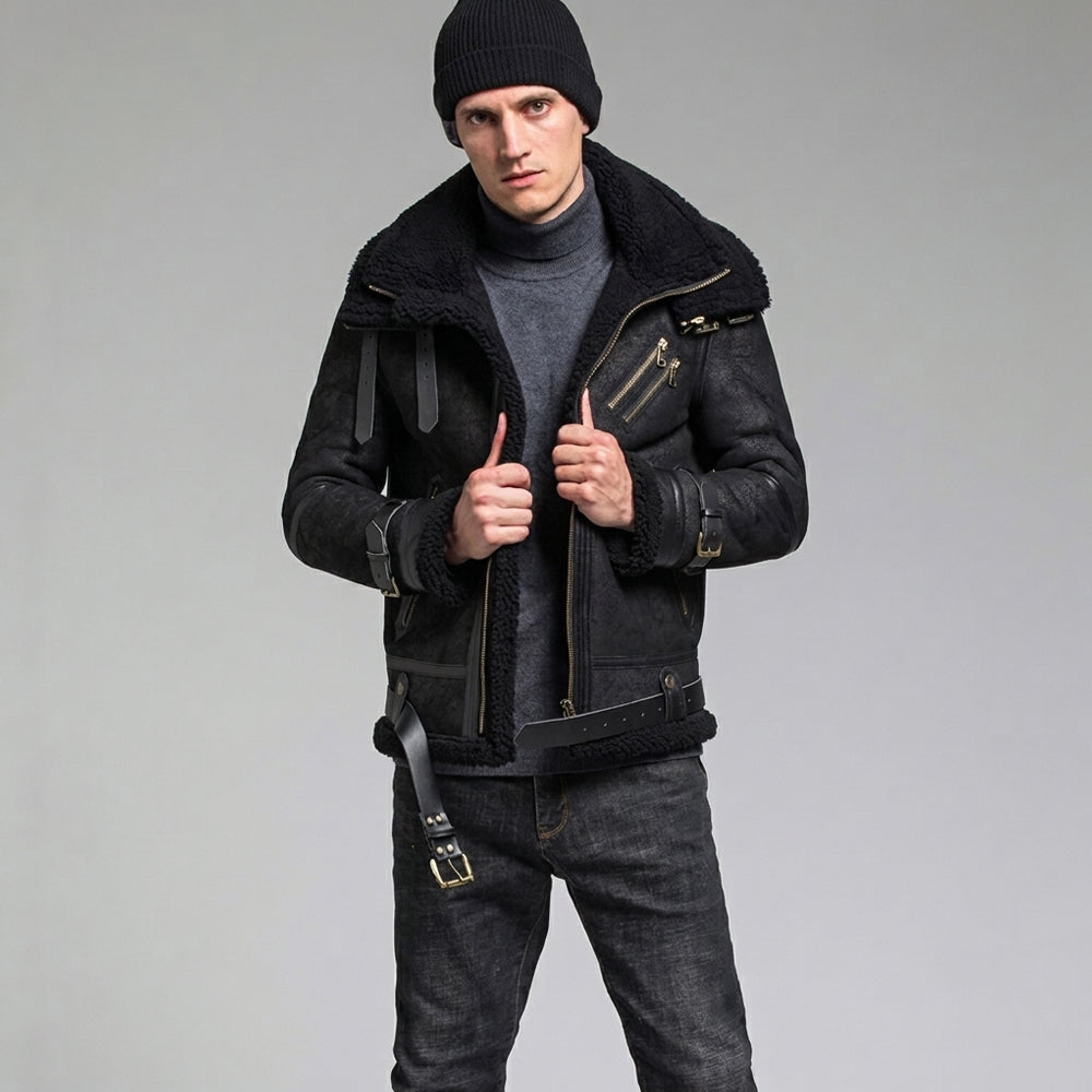 Front view of male model wearing all-black B3 asymmetric shearling biker coat with beanie and grey turtleneck