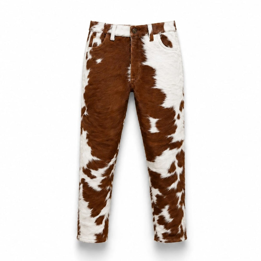 Front view of handmade men's cowhide leather pants with brown and white cow print.