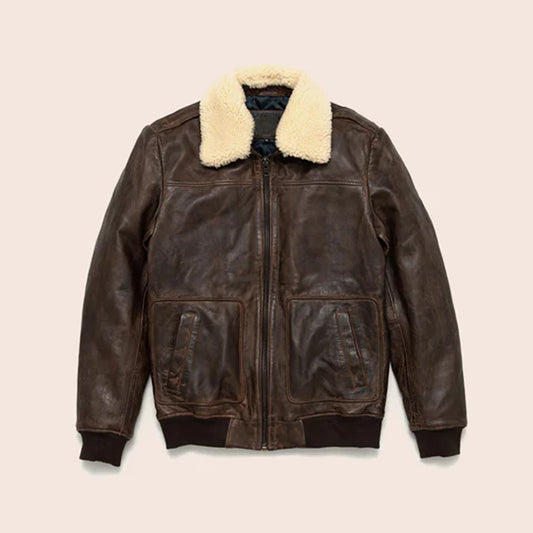 A front flat lay view of a men's vintage A2 distressed brown leather bomber jacket featuring a plush cream shearling collar and rib-knit cuffs.