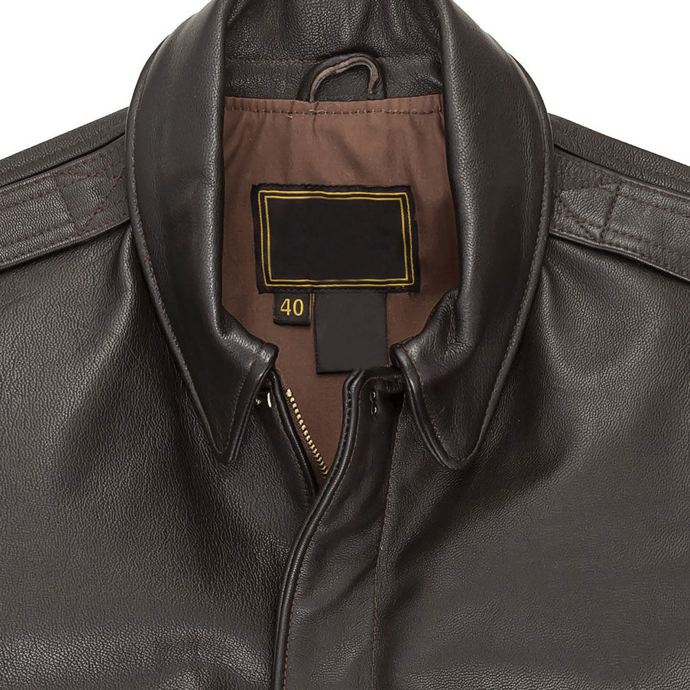 Macro close-up of snap-down collar, brass zipper, shoulder epaulettes, and russet lining on goatskin A-2 jacket.