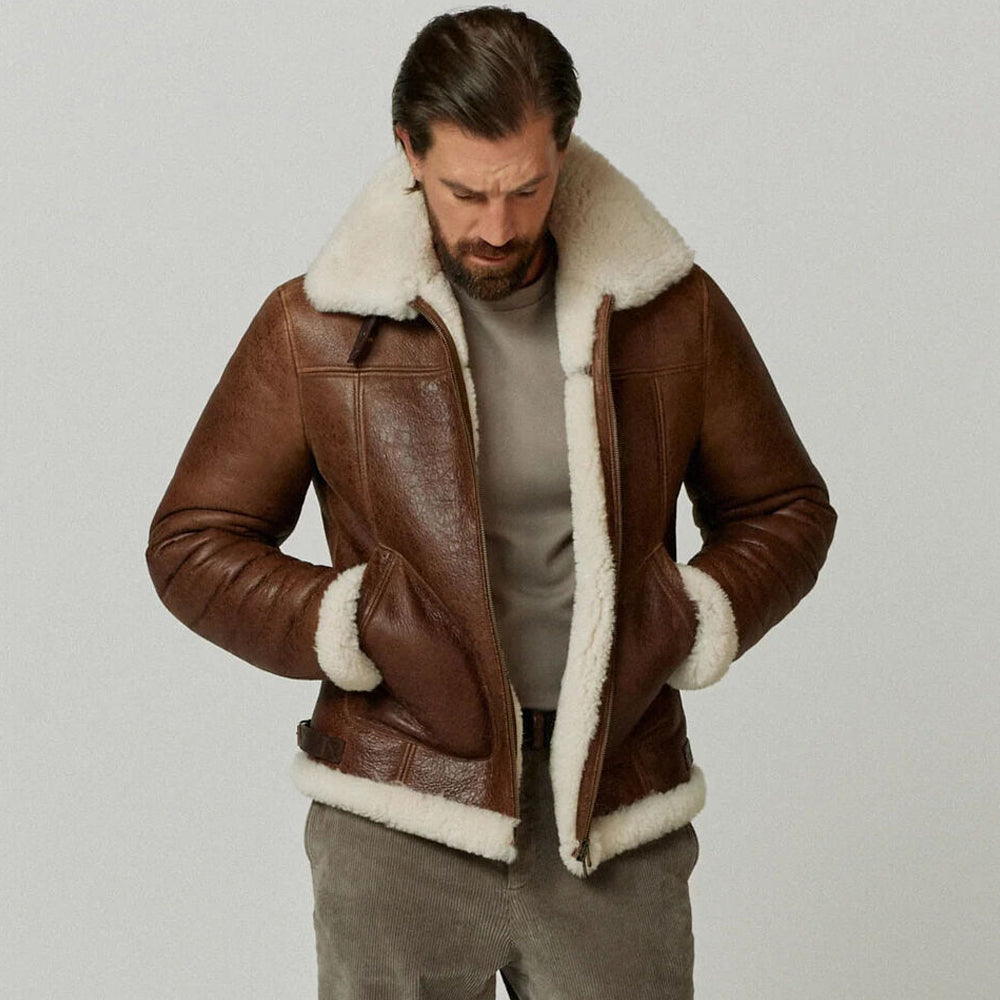 Model wearing men's antique brown shearling flight coat with hands inside diagonal welt pockets