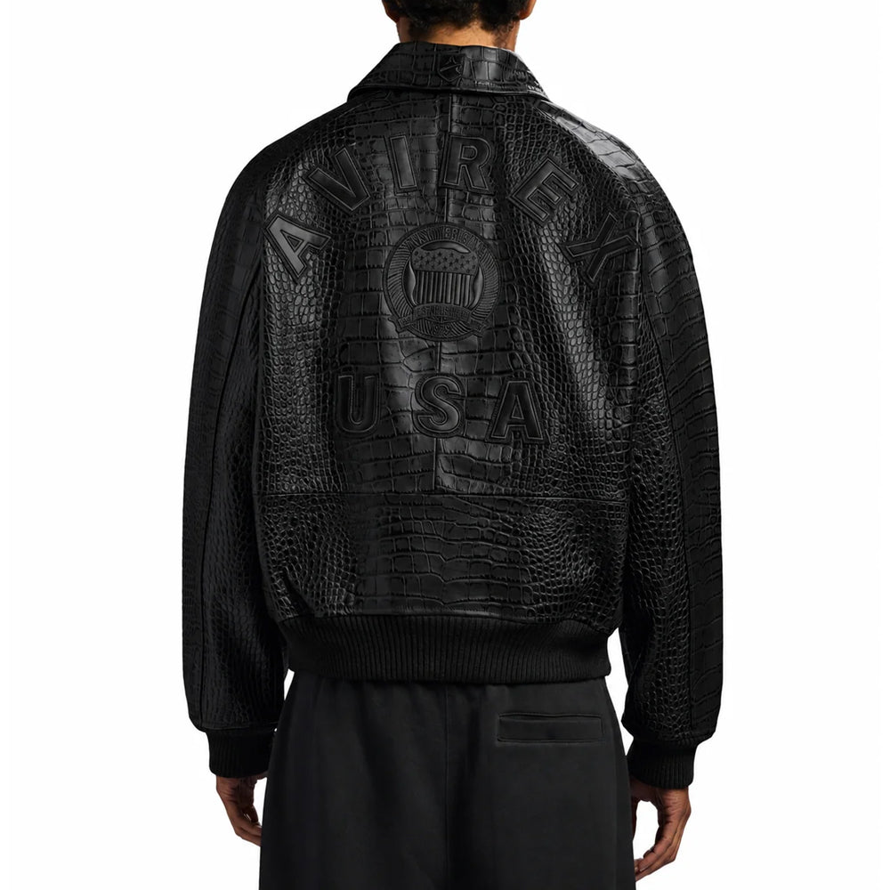 Rear model view of men’s black Avirex bomber featuring tonal shoulder lettering, USA patches and ribbed hem