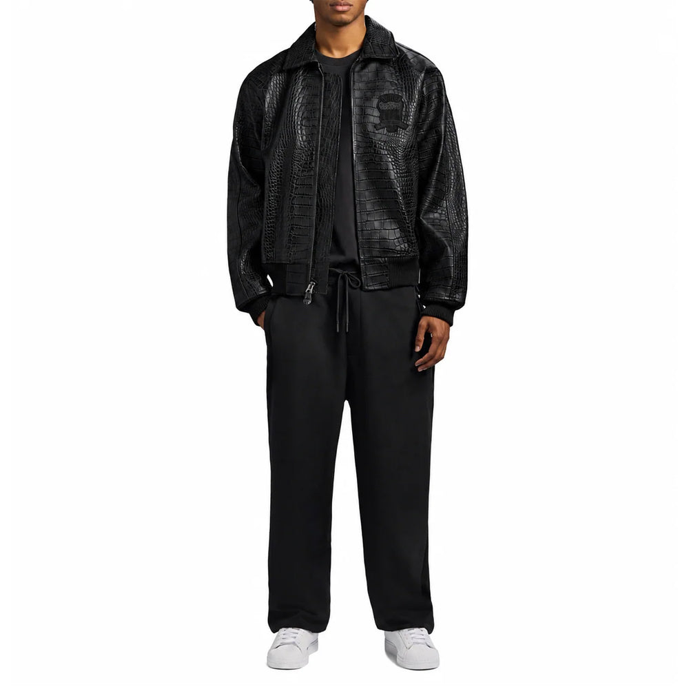 Full-length model styling the men’s Avirex black embossed leather jacket open over monochrome streetwear