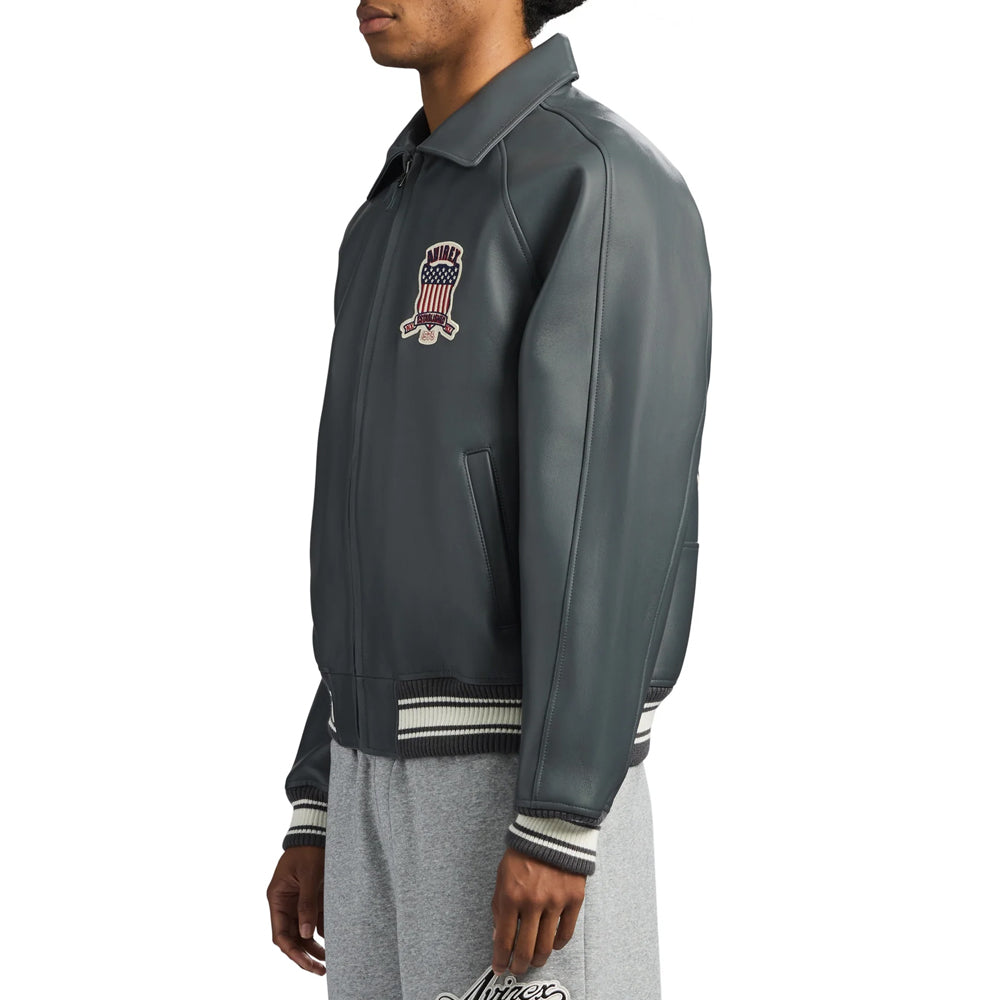 Side profile of men’s gray lambskin Avirex flight bomber highlighting raglan-inspired sleeve seam and rib-knit cuff