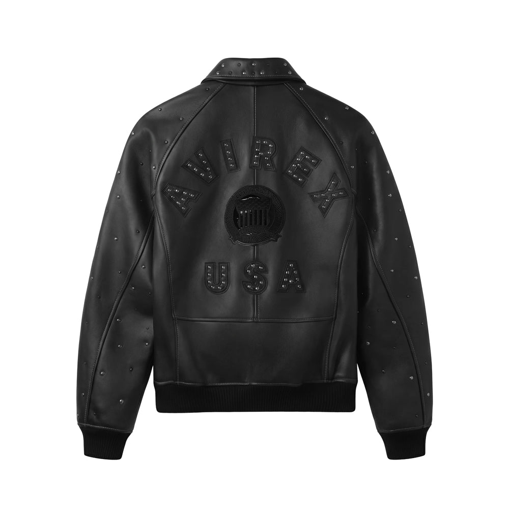 Back view of black Avirex Icon bomber showing stud-filled AVIREX USA appliqués, central shield and raglan seams