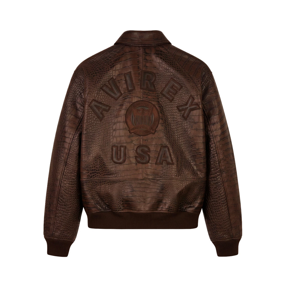 Back view of brown Avirex croc-effect bomber showing raised AVIREX USA lettering and circular aviation crest