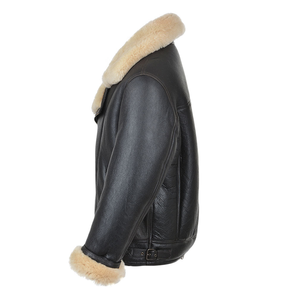 Side profile of men's black asymmetrical shearling biker jacket displaying pebbled leather texture and waist belt buckle