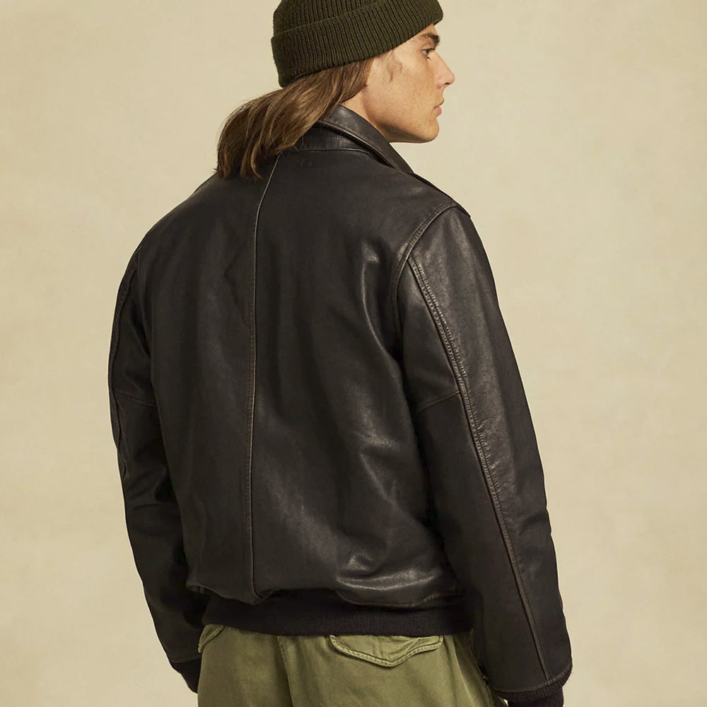 Rear three-quarter model view of men’s black aviation bomber highlighting clean paneling and articulated sleeves