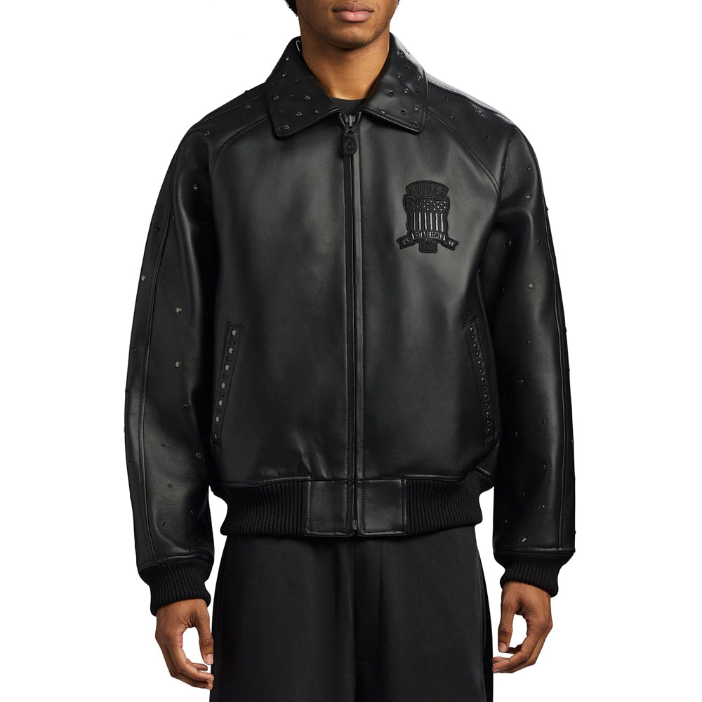 Man wearing the black Avirex studded leather jacket with exposed zipper, rib-knit hem and tonal chest badge