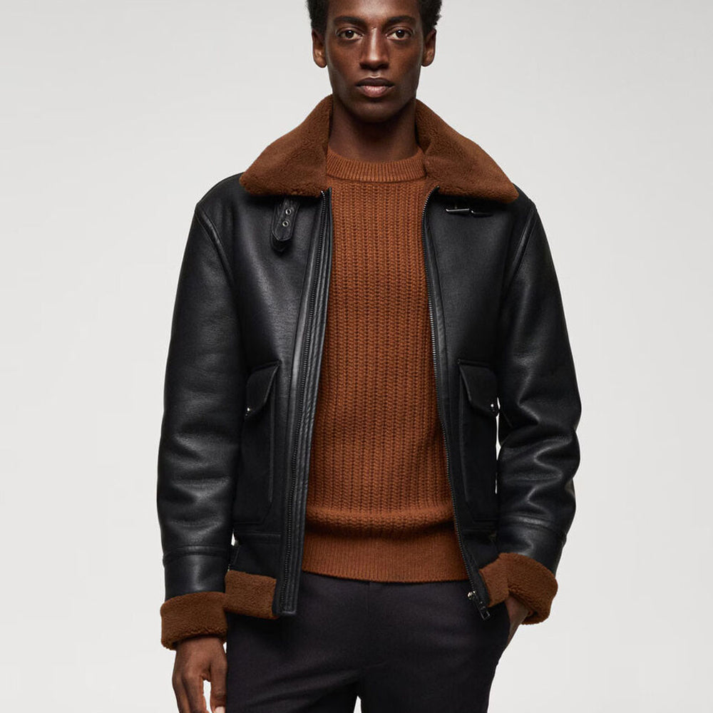 Model wearing men's black flight shearling coat over brown knit sweater displaying cargo flap pockets