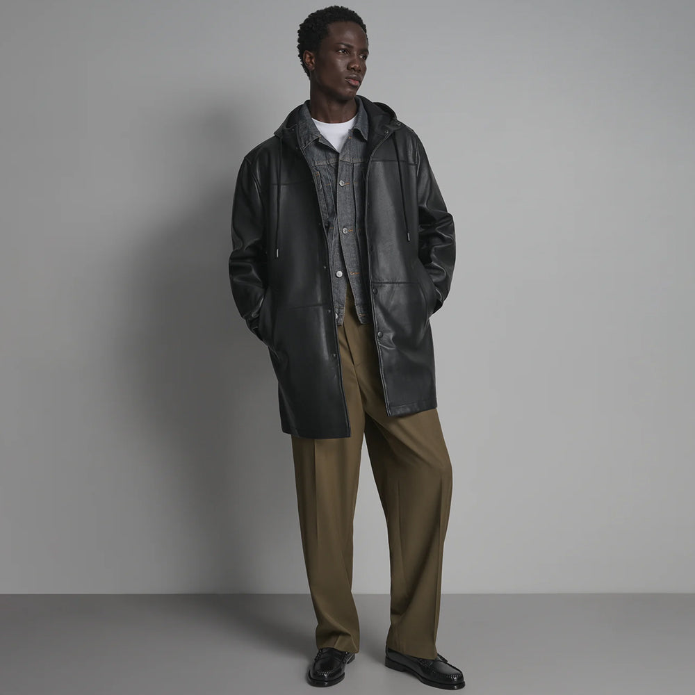 Full front view of men’s black leather hoodie worn open over a denim jacket with drawcord hood and welt hand pockets.