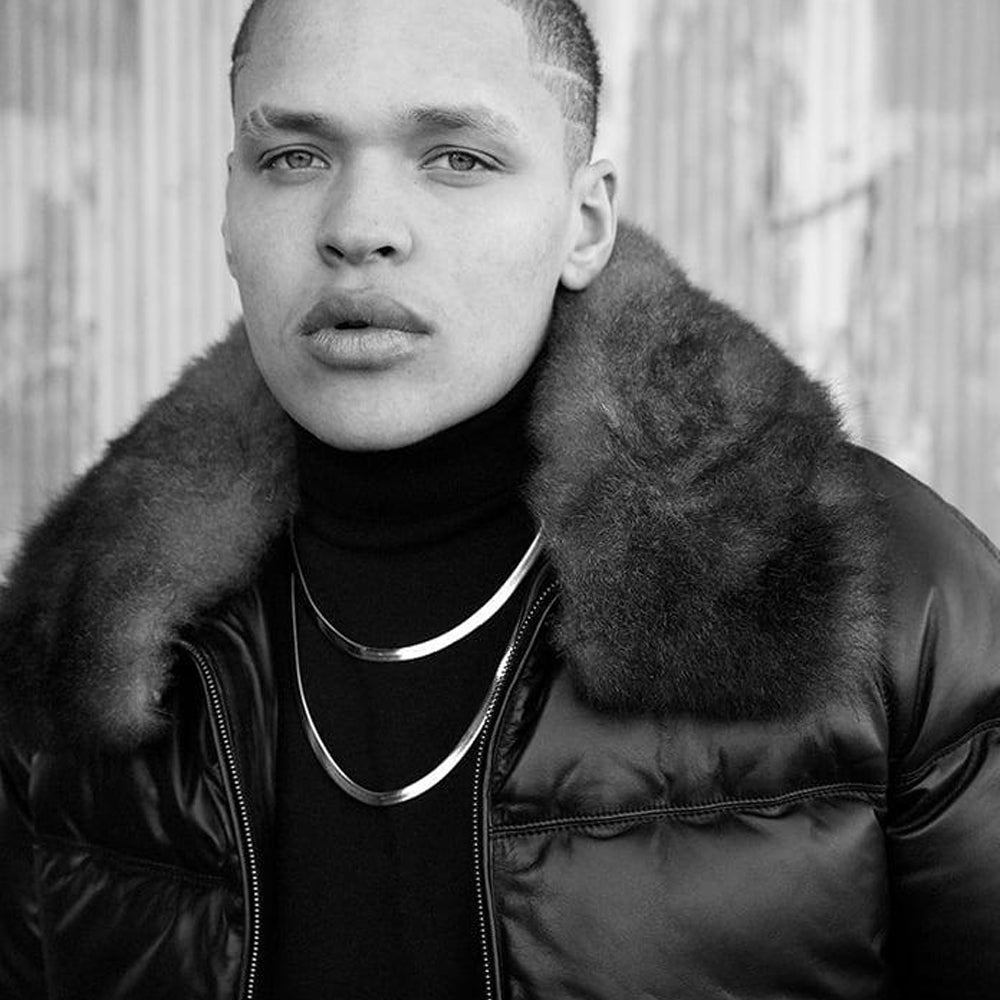 Close-up portrait of man wearing black leather jacket with thick shearling collar