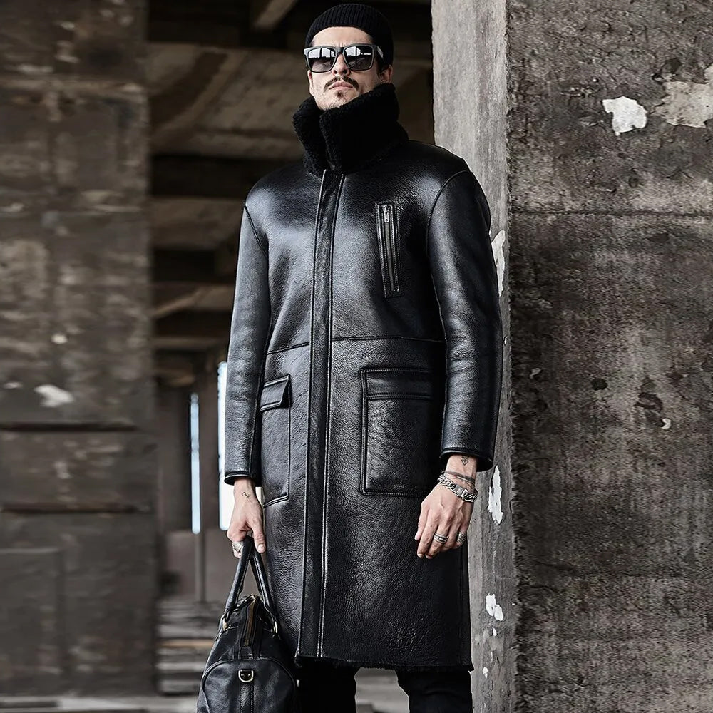Man wearing black leather reversible trench coat holding duffle bag