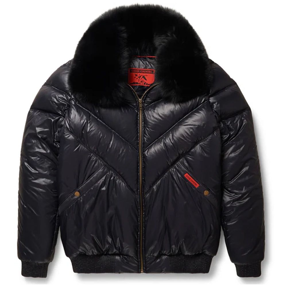 Front view of the men's technical black nylon V-bomber jacket highlighting the symmetric zip and black fox fur collar.