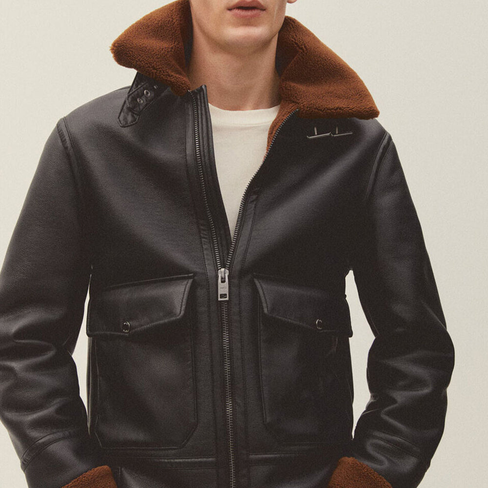 Front view of model wearing men's black shearling bomber jacket unzipped over white t-shirt