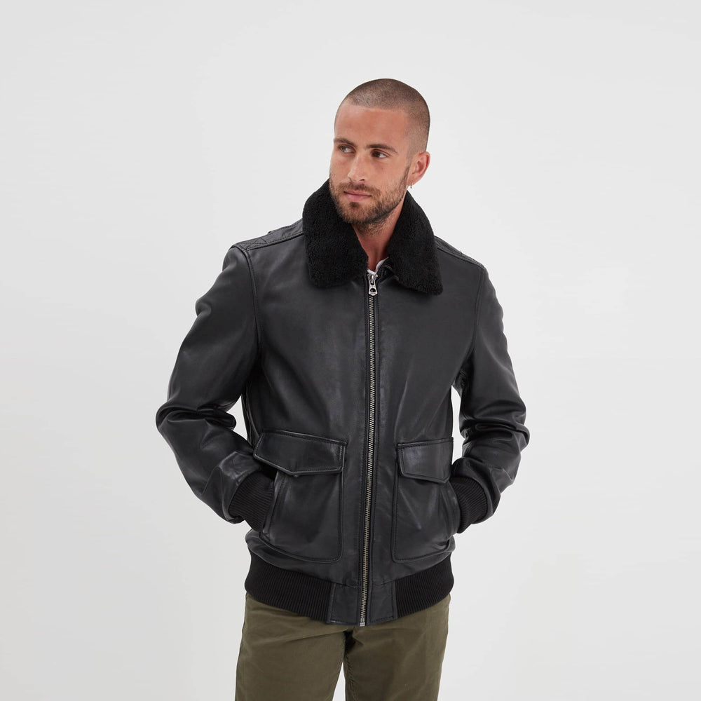 Front view of men's black sheepskin aviator bomber jacket with removable black shearling collar and dual-entry flap pockets.