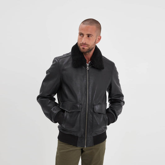 Front view of men's black sheepskin aviator bomber jacket with removable black shearling collar and dual-entry flap pockets.