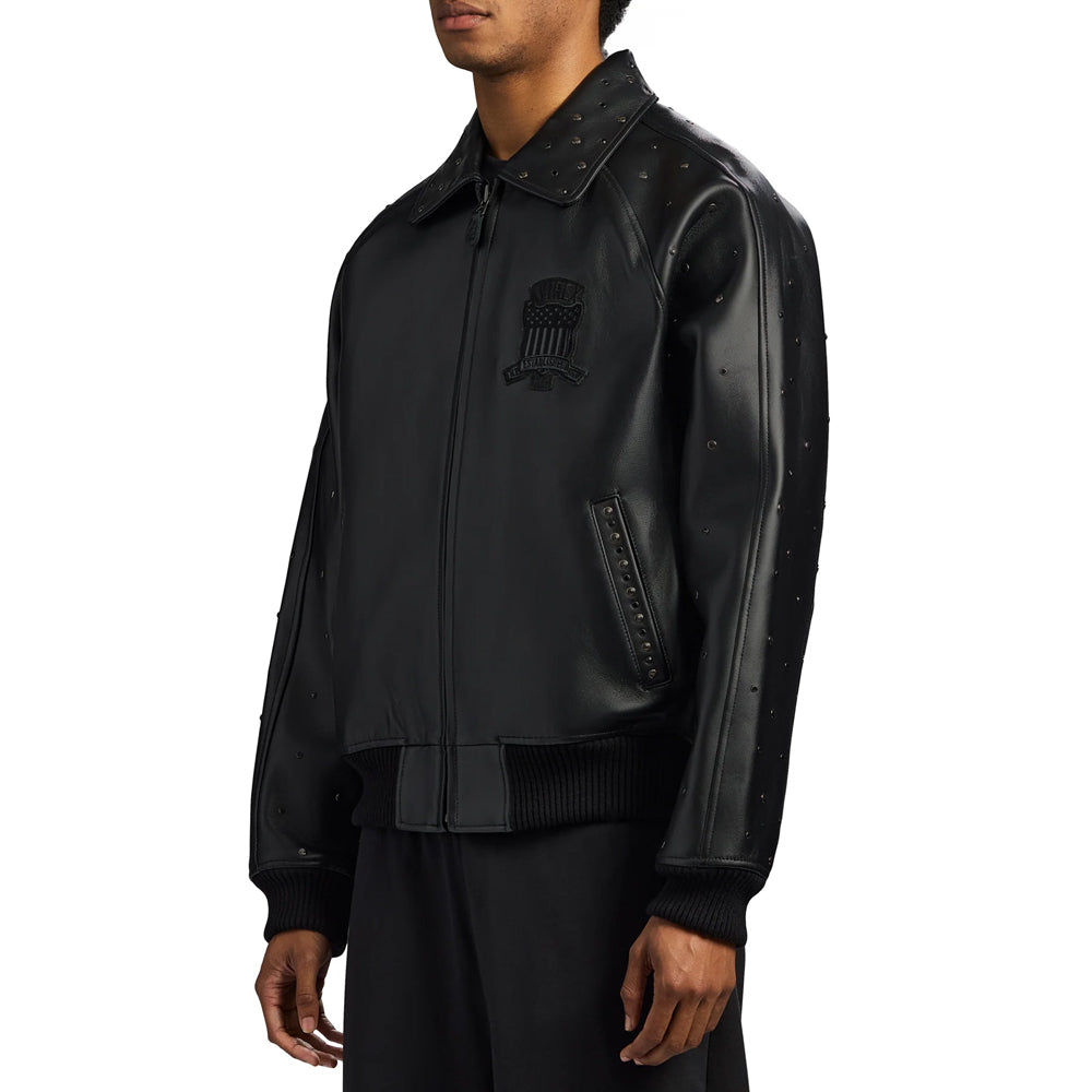 Angled view of men’s black goatskin bomber highlighting studded collar, outer sleeve and slanted pocket welt