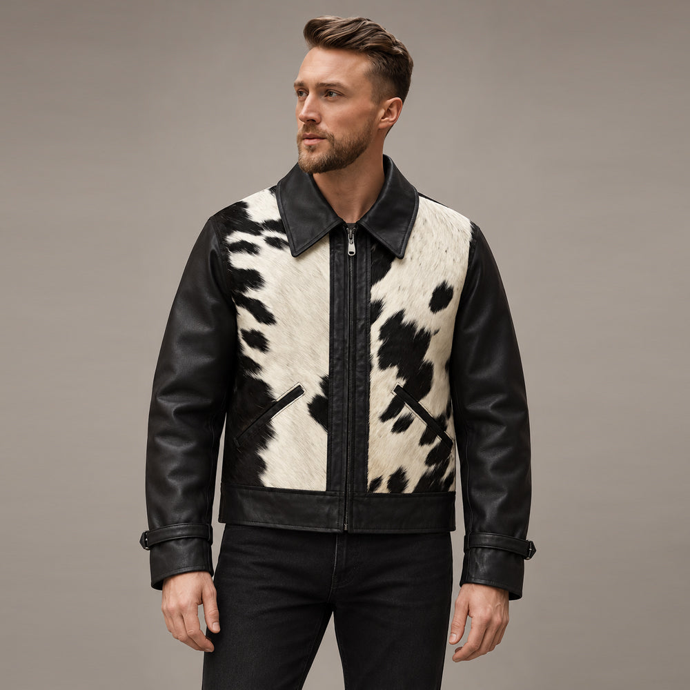 Model wearing a men’s black and white hair-on cowhide ranch jacket with smooth leather sleeves