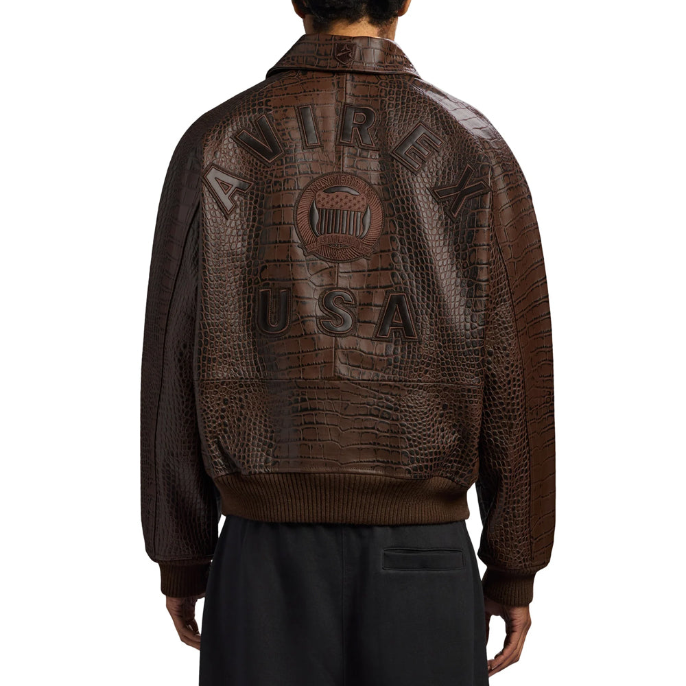 Rear model view of men’s brown Avirex flight bomber with dimensional logo appliqués and ribbed hem