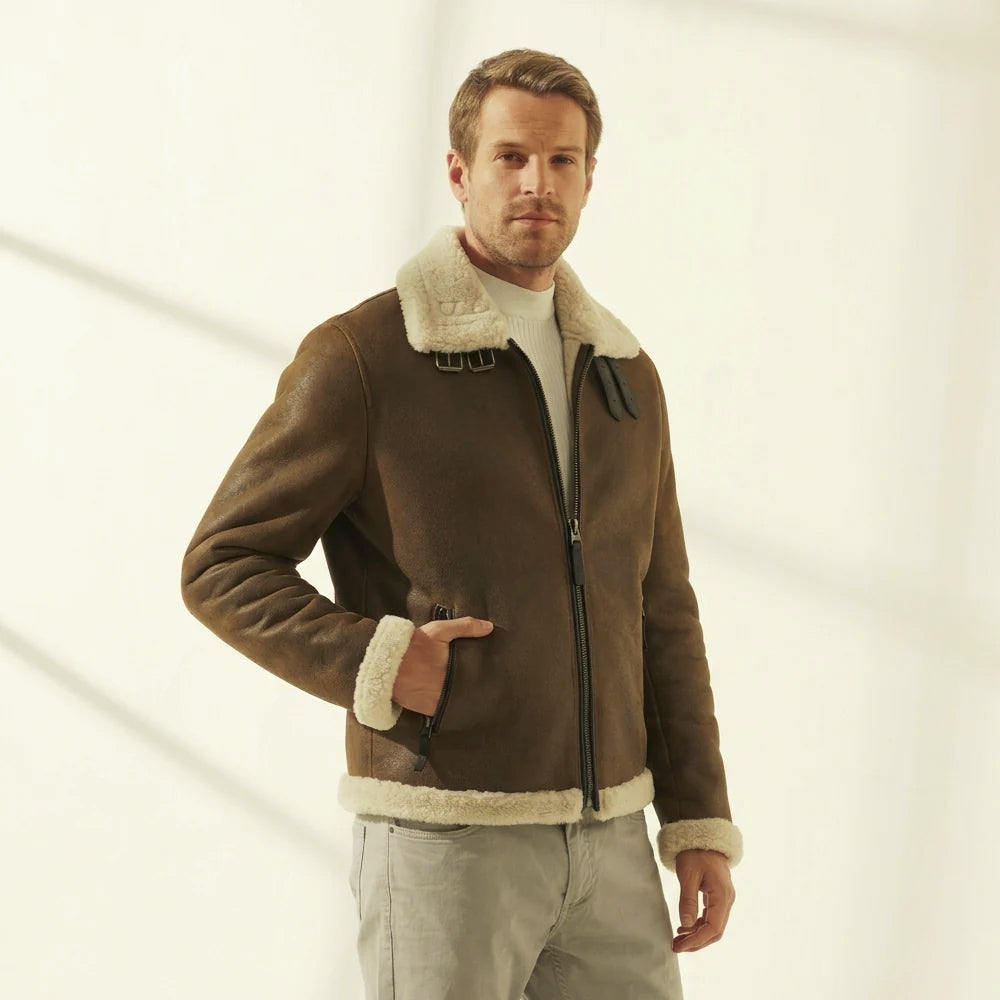 Three-quarter view of the men’s brown flight jacket with shaped leather sleeves, exposed shearling cuffs and zip pocket