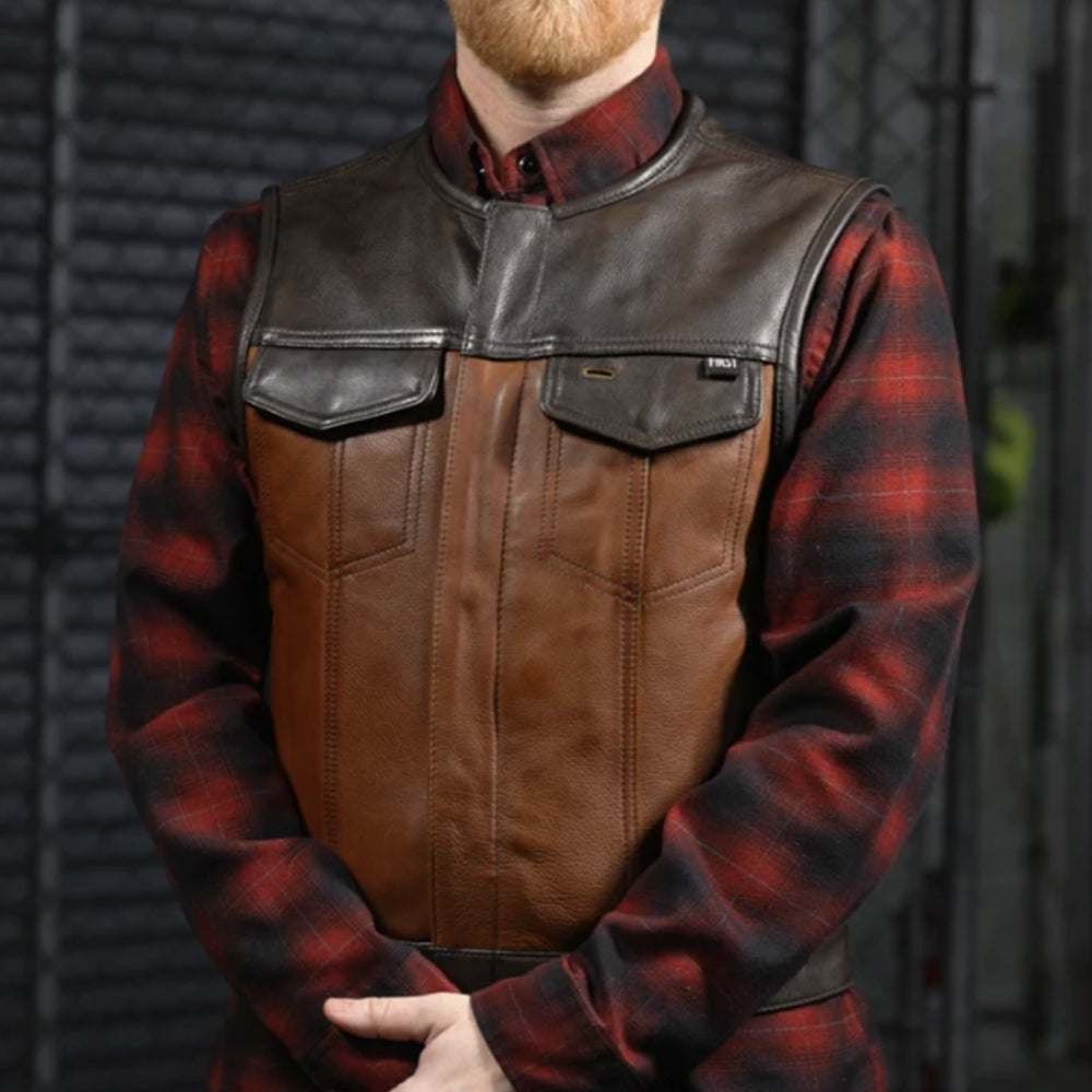 Man wearing a brown two-tone leather biker vest over a red and black flannel shirt
