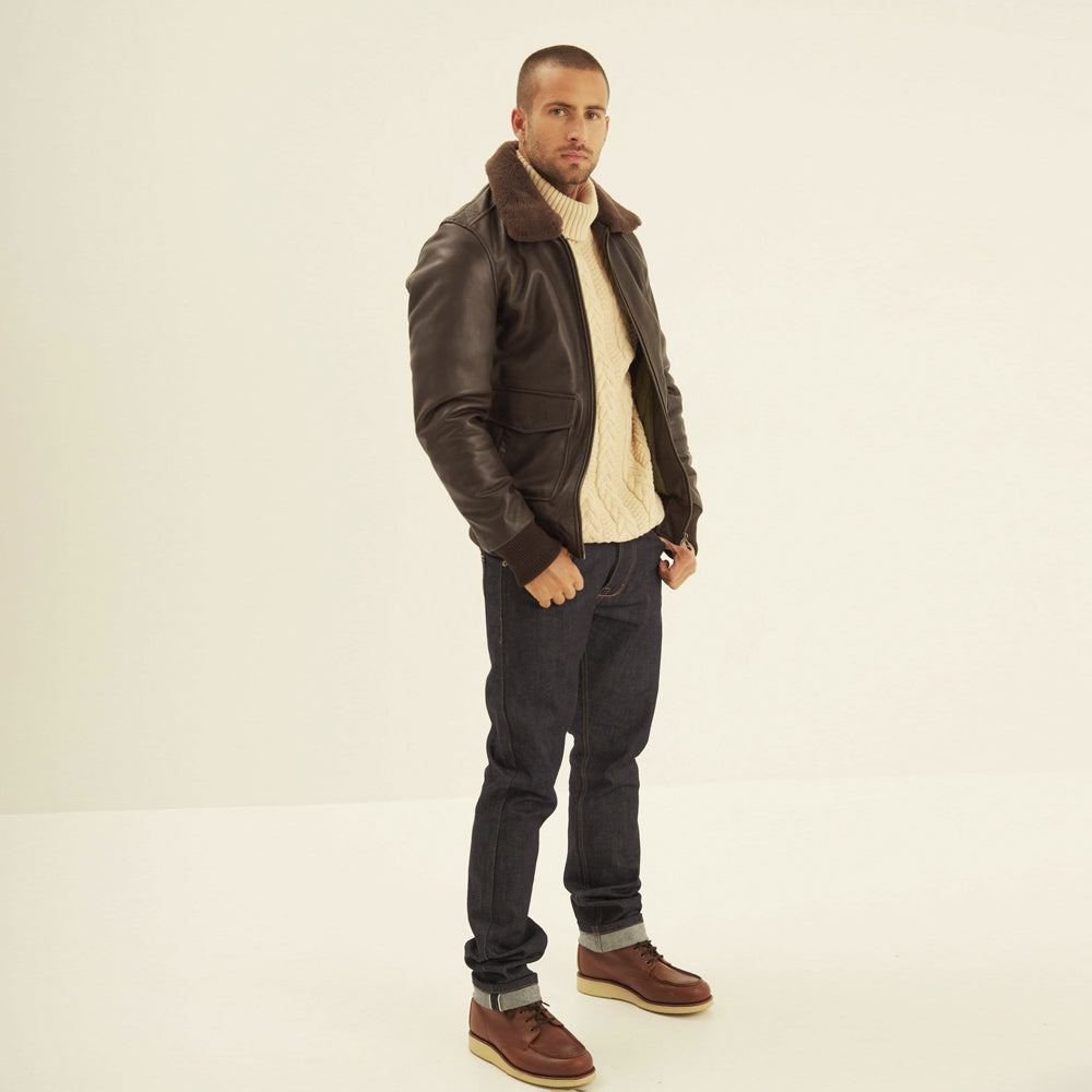 Full-length view of men's brown sheepskin aviator bomber jacket with dark-brown shearling collar and knitted trim.