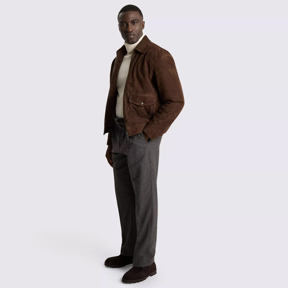 Full-length styling of men’s brown suede flight jacket with cream turtleneck, gray trousers and dark shoes