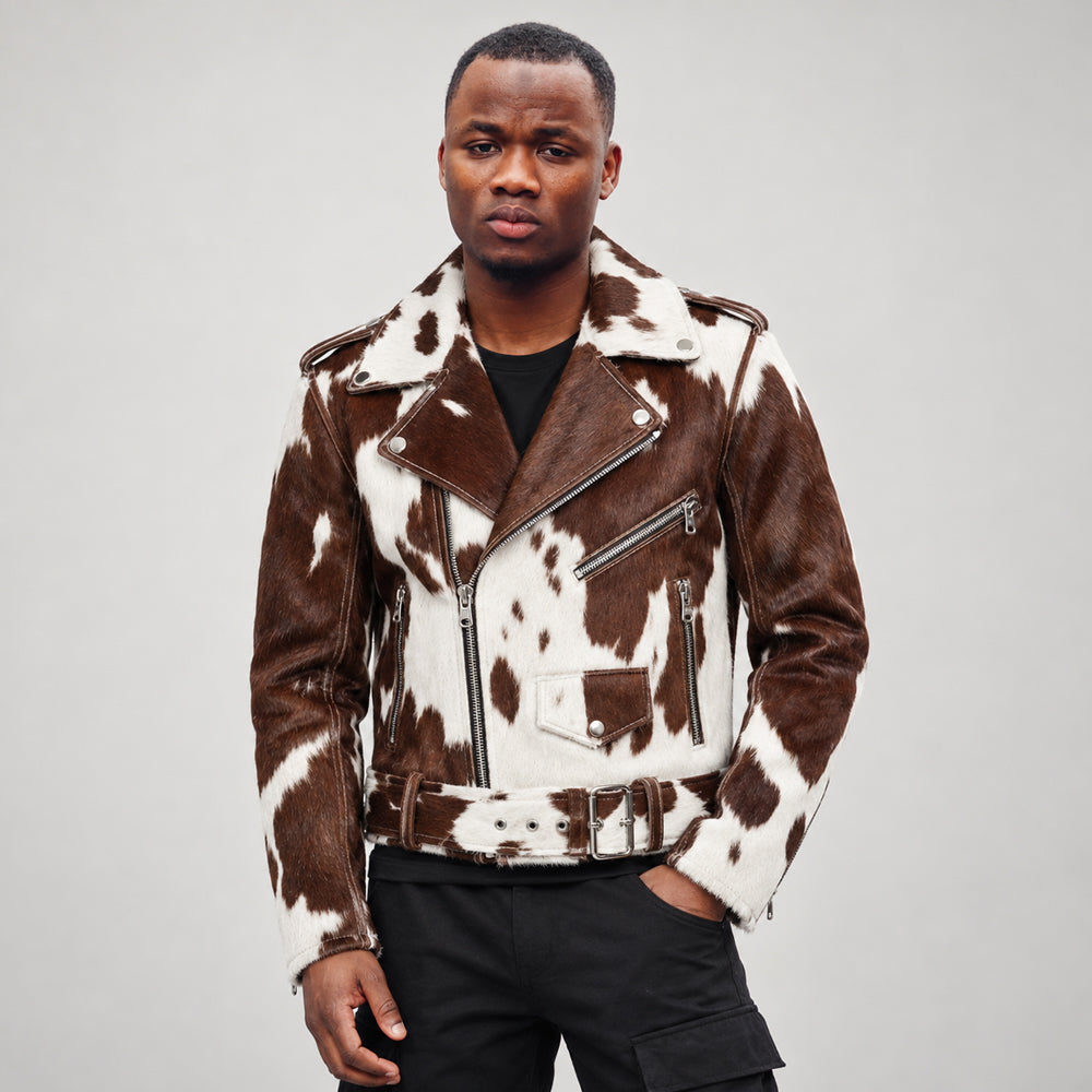 Model wearing a men’s brown and white hair-on cowhide double rider jacket with asymmetrical zipper and fixed belt