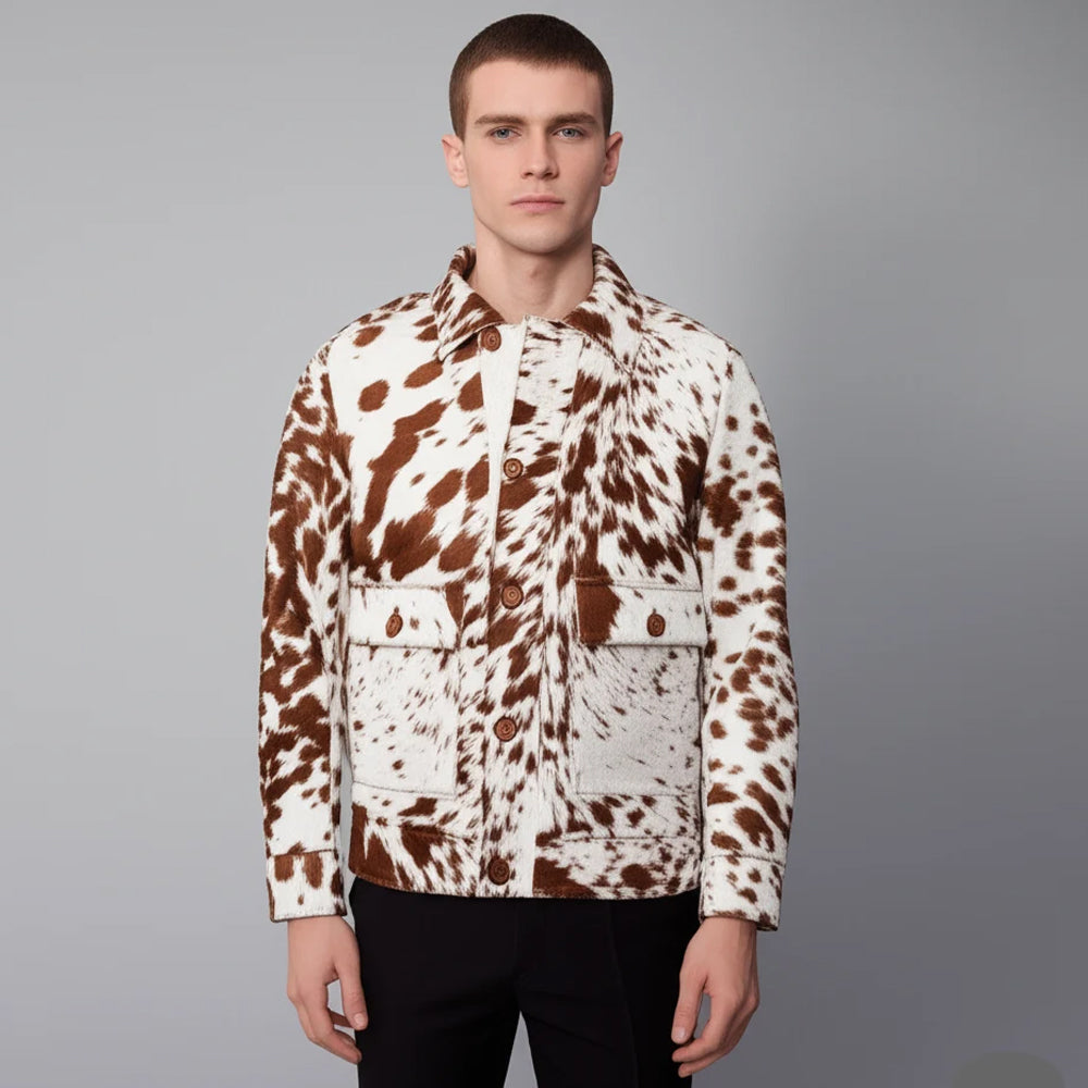 Front view of a man wearing a brown and white hair-on cowhide chore jacket with button closure and flap pockets