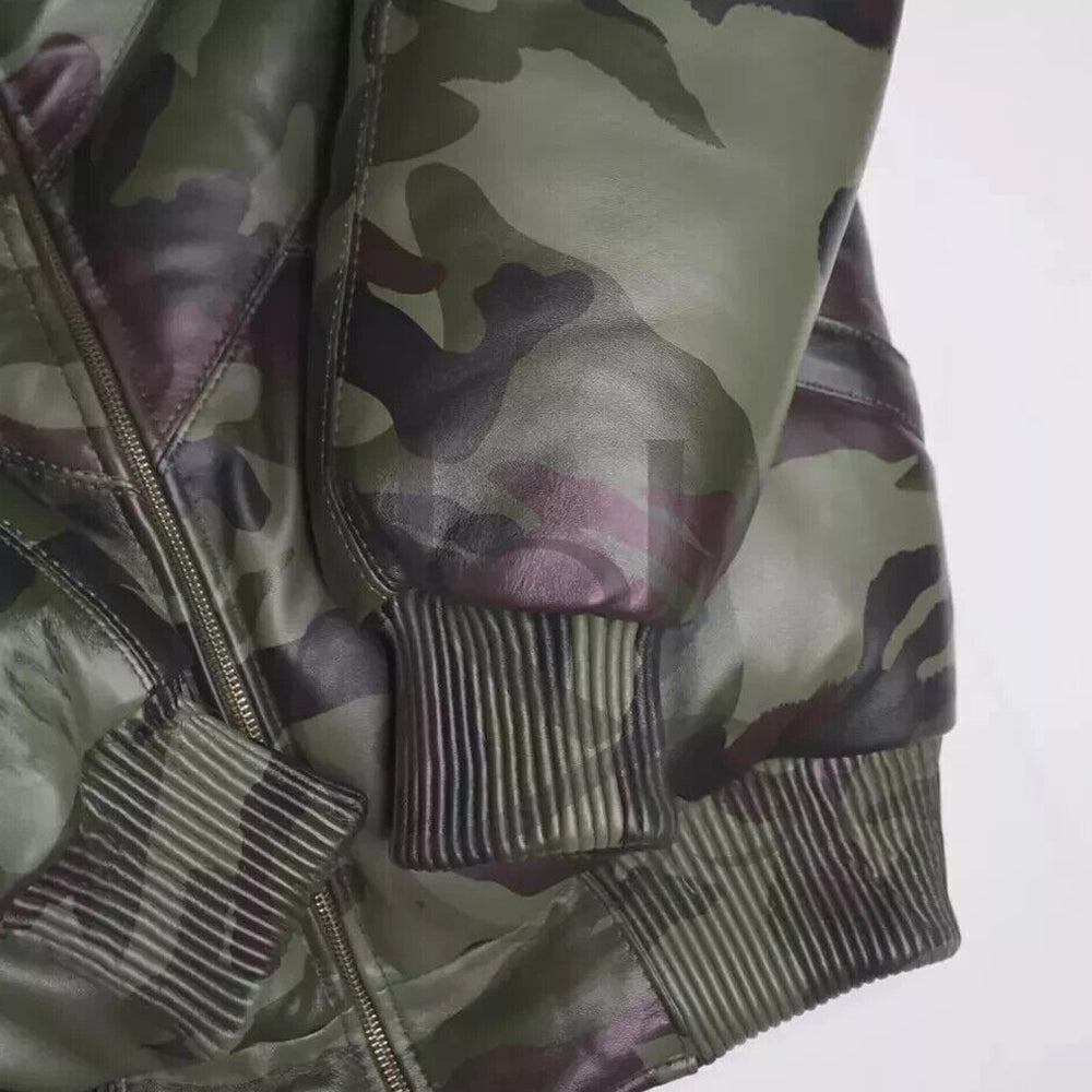 Detail view of the olive-toned heavy ribbed elastic knit waist and cuffs on the camo leather bomber puffer.