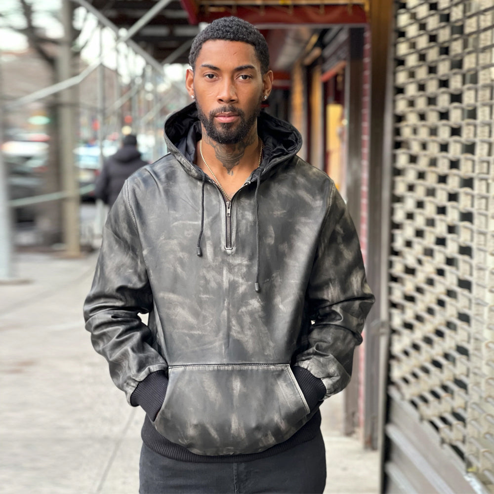 Men’s charcoal-black half-zip leather pullover hoodie showing fixed drawcord hood, dual-entry pouch, ribbed cuffs and waistband.