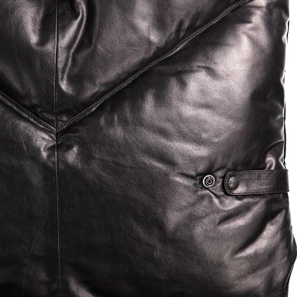 Close-up of glossy black calfskin chevron panel and snap-position leather waist adjustment tab