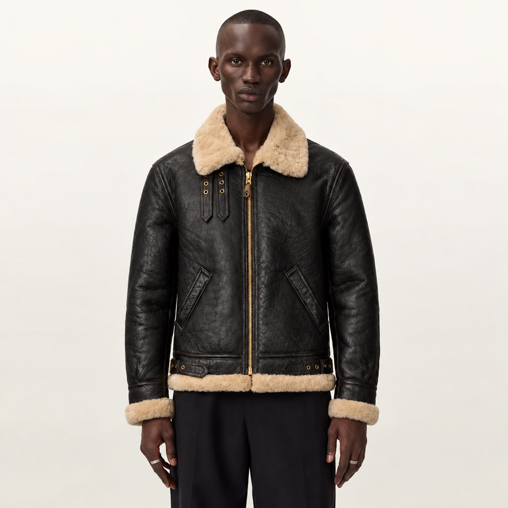 Male model wearing a dark chocolate B-3 aviator jacket with cream shearling collar, exposed cuffs, welt pockets and regular fit.
