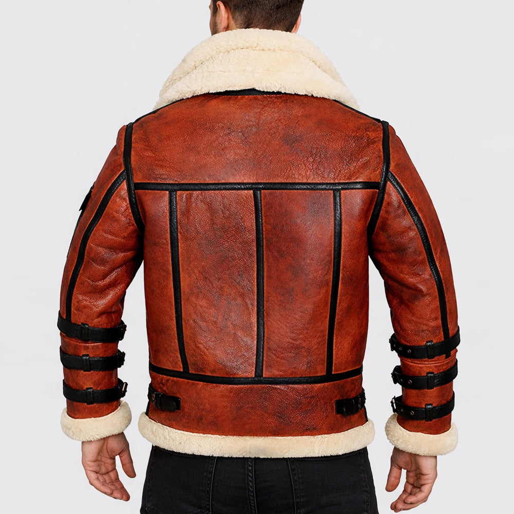 Rear view on model wearing men's cognac rust-brown shearling flight coat with black seam piping.