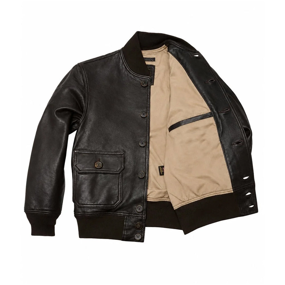 Open interior of men’s button-front A-1 jacket displaying tan cotton lining, leather-trimmed inner welt pocket and ribbed hem.