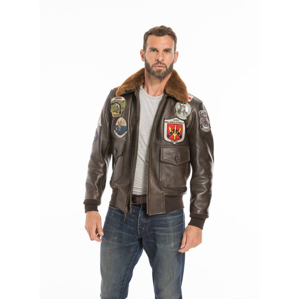 Studio front portrait of model wearing men's cowhide patched bomber jacket with jeans.