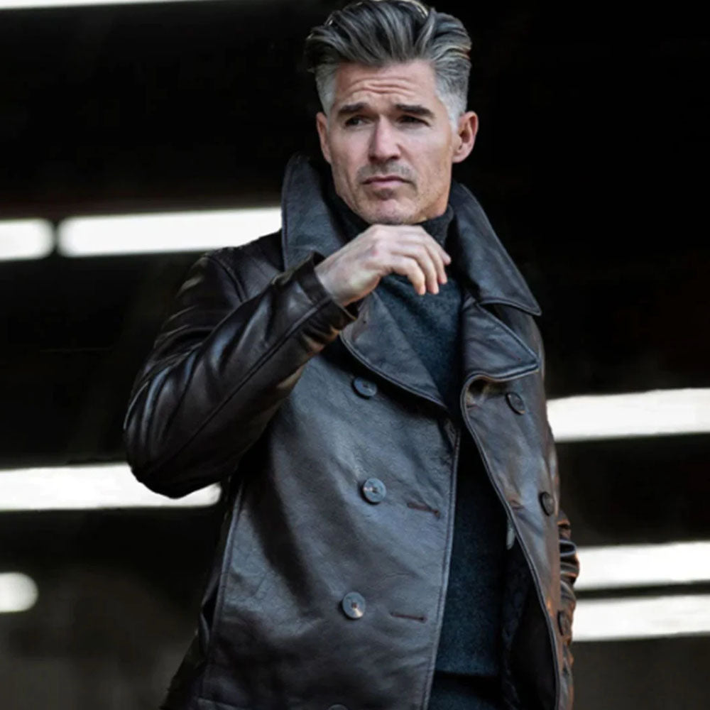 On-model studio shot of male model in grey turtleneck wearing dark brown double-breasted leather pea coat bomber.