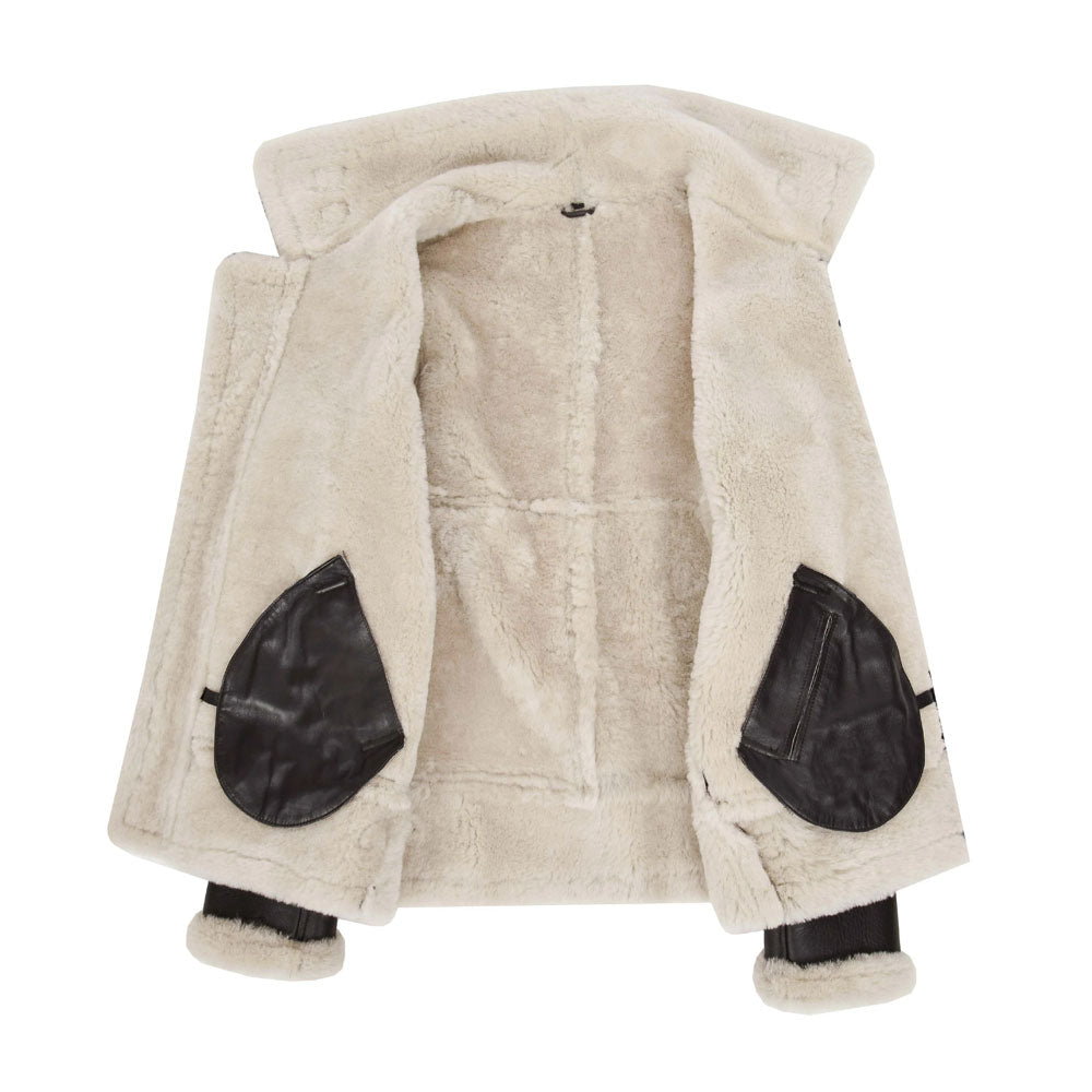 Interior view of men's dark brown sheepskin jacket displaying off-white fur lining and dual inside leather patch pockets