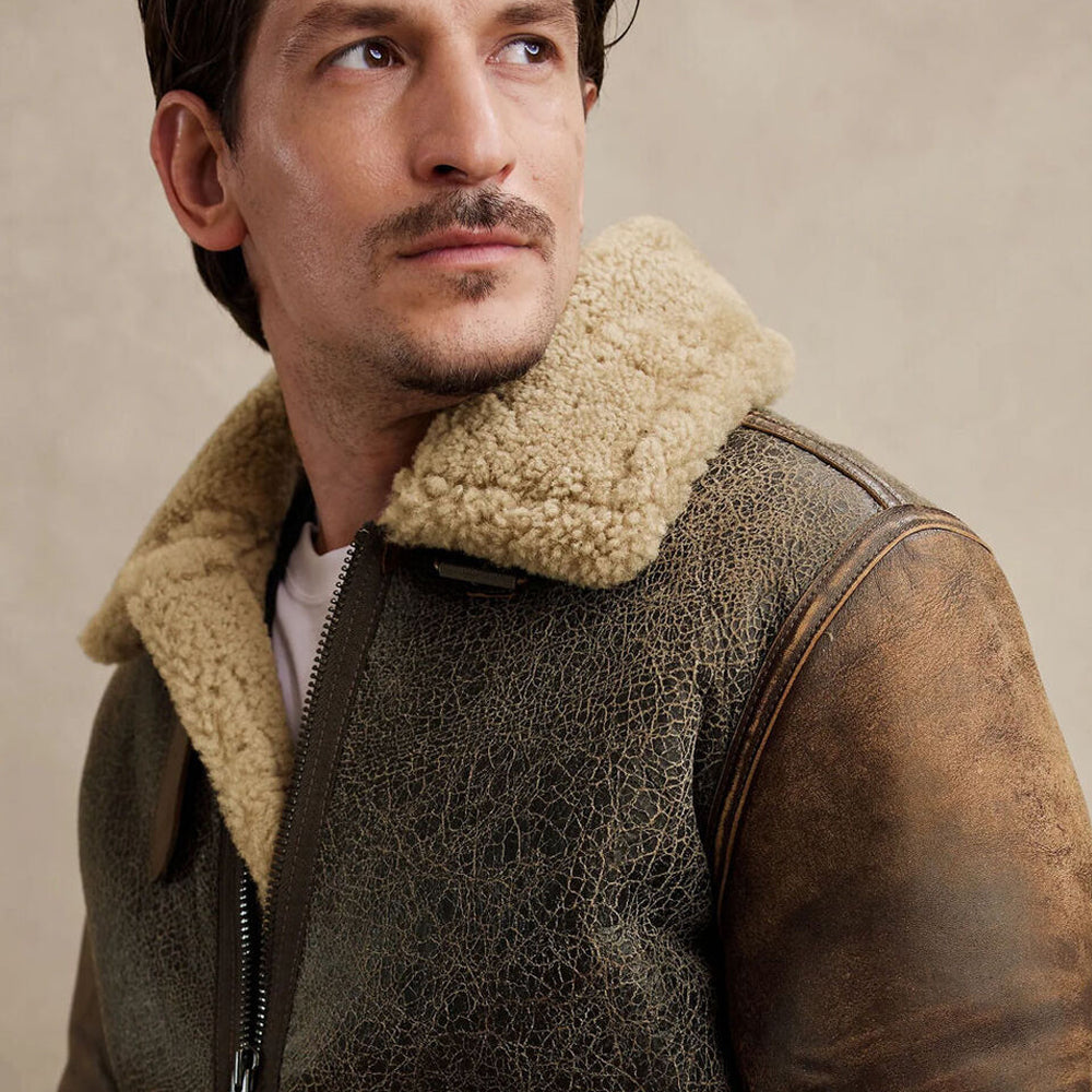 Close up shot of model wearing distressed B3 flight jacket displaying weathered crackled hide texture and cream fur collar