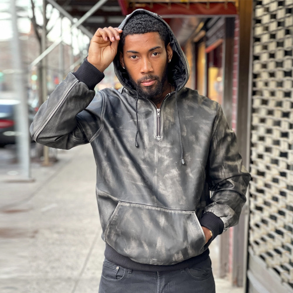 Front view of men’s distressed black leather hoodie with hood raised, silver half zipper, smoky charcoal finish and kangaroo pouch.