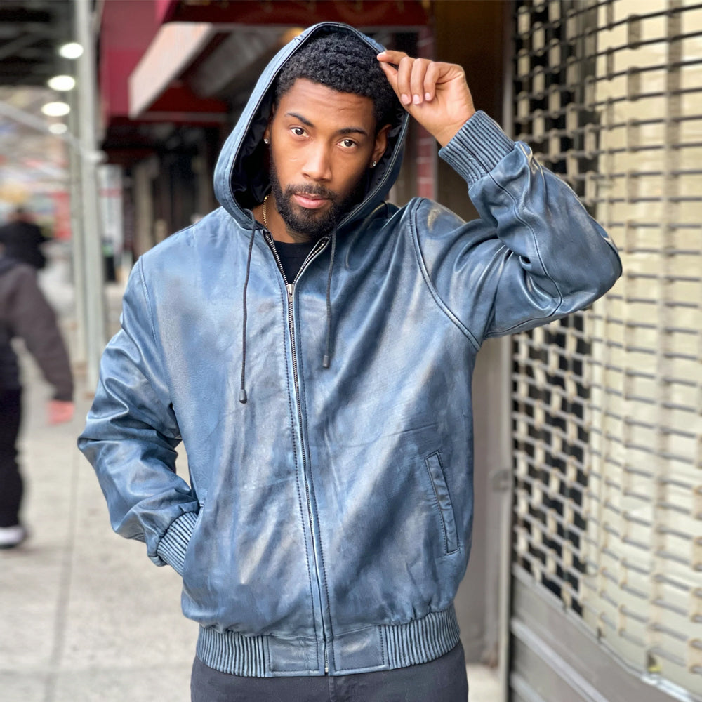 Front view of men’s distressed blue leather hoodie zipped closed with fixed drawcord hood, welt pockets and rib-knit trim.