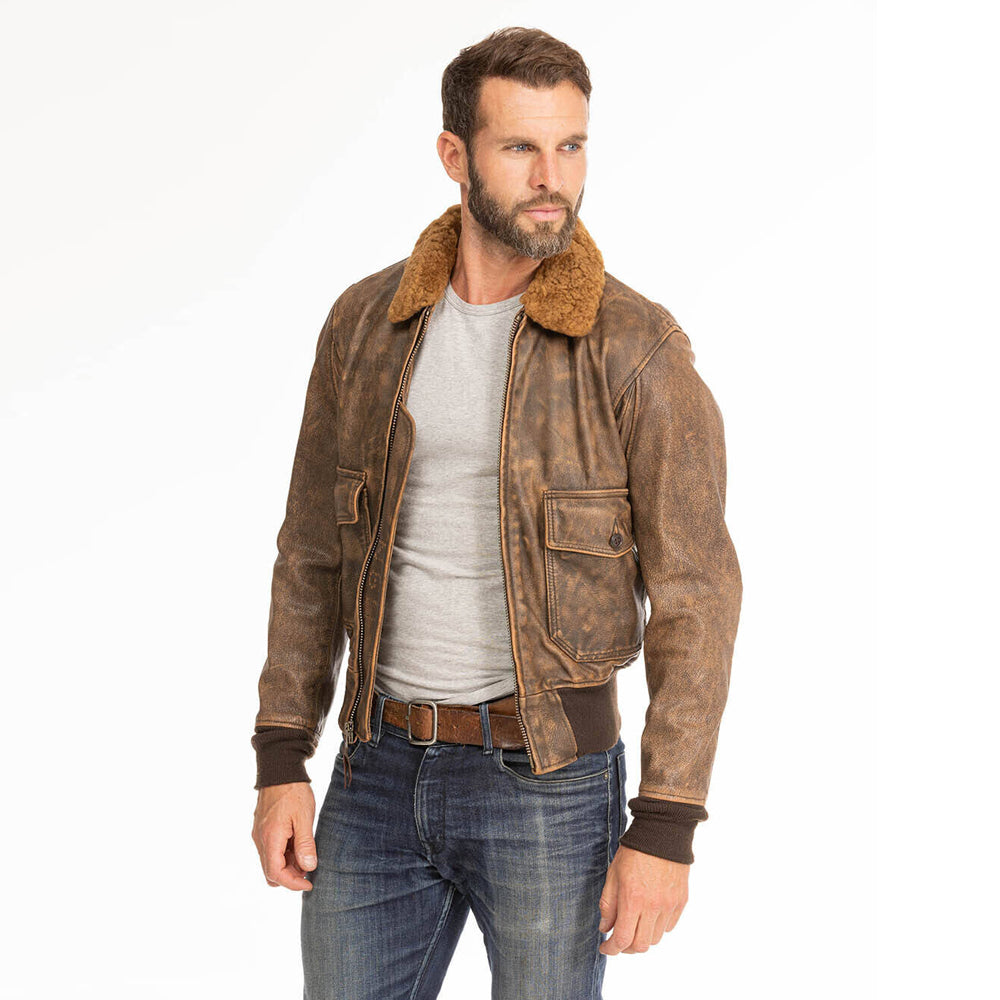 Standing front view of model wearing unzipped men's distressed G-1 aviator jacket over grey t-shirt.