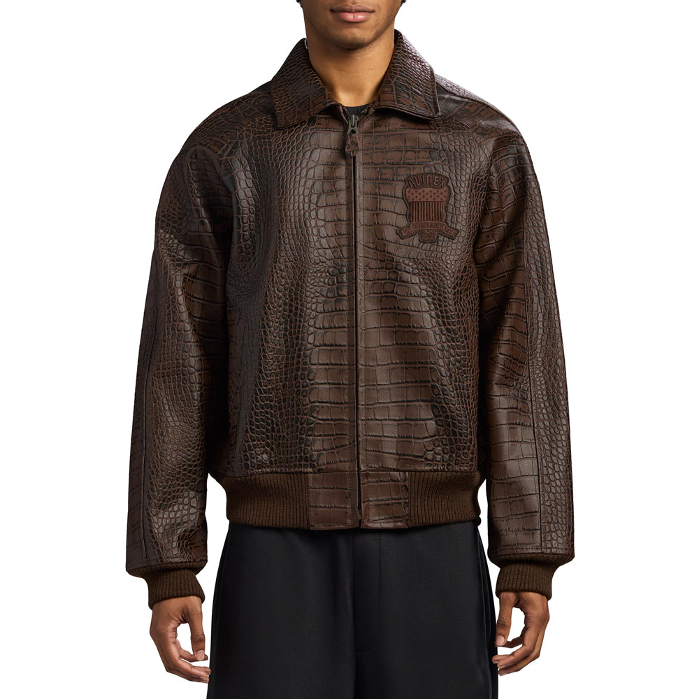Man wearing an espresso Avirex textured leather bomber with tonal chest patch and rib-knit waistband