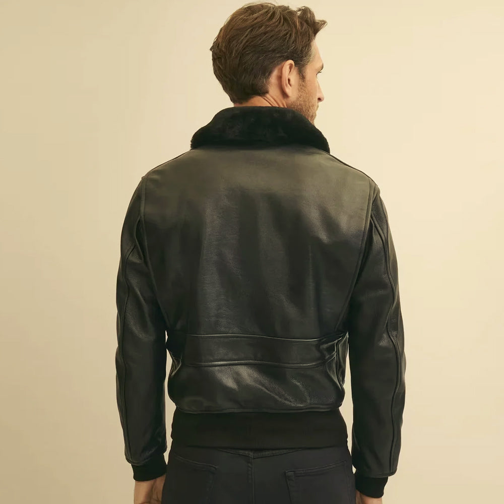 Rear model view of men’s extended-fit black bomber showing clean upper back, horizontal lower panel and rib-knit waistband