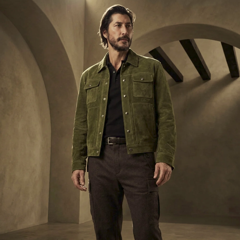 Front view of men’s forest green goat suede trucker jacket with silver snap closure, four pockets and straight waist-length hem.