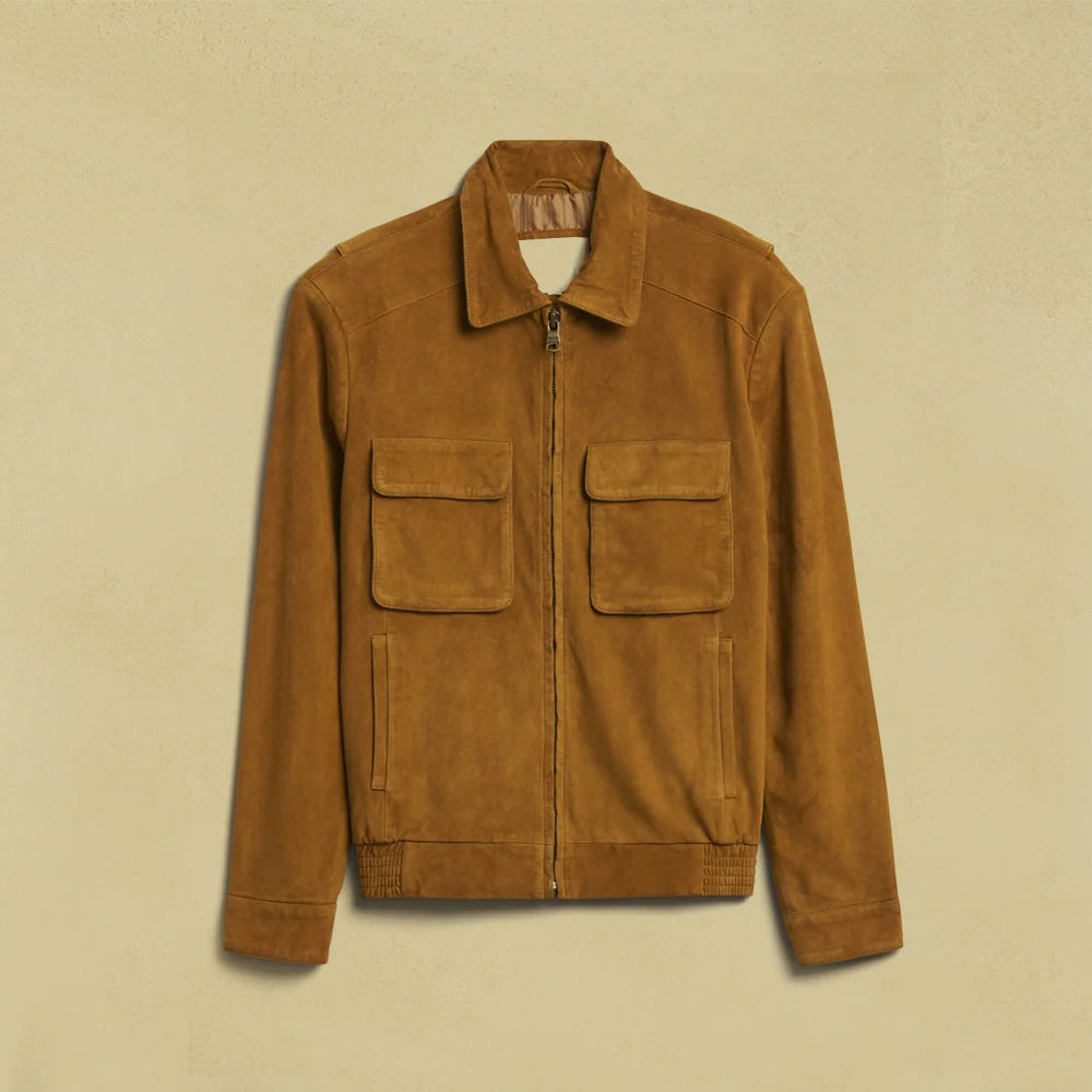 Flat lay of a men’s golden-brown goatskin suede jacket with twin chest flaps, lower welt pockets and side-elastic hem