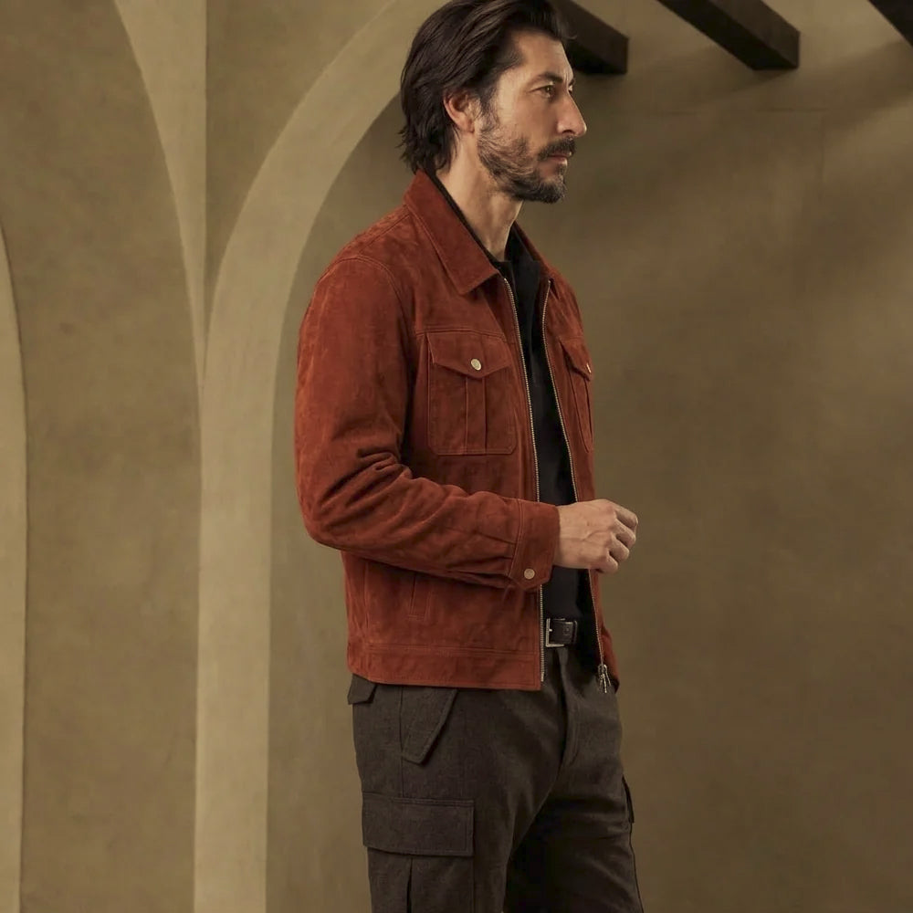 Angled side view of men’s four-pocket suede workwear jacket with button cuff, flap chest storage and tonal sleeve seams.